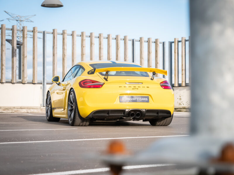 Aileron arrière avec double sortie d'échappement – PORSCHE – CAYMAN GT4 – 2016 – Jaune Racing – 385 ch – Flat 6  – 22 900 km – Transmission : Manuelle – Origine Allemagne – Privaty Cars – Showroom de voitures de sport haut de gamme à La Rochelle